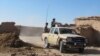An Afghan National Army (ANA) soldiers drive at an outpost in Helmand province, Dec. 20, 2015. 