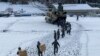 In this photo provided by Japanese Ministry of Defense, members of Japan Self-Defense Forces carry relief goods in the earthquake-hit city Wajima, Ishikawa prefecture, Japan, Jan. 8, 2024.