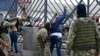 Soldiers frisk two men suspected of belonging to a criminal gang remain detained during a joint operation between the Ecuadorean National Police and members of the armed forces to prevent violent acts, in Guayaquil, Ecuador, on Jan.15, 2024.