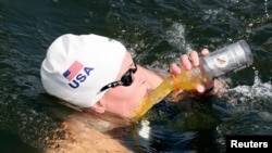 Haley Anderson of the U.S. tries to drink during the women's 10km marathon.