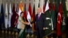 Indian Foreign Minister Sushma Swaraj (L) shakes hand with Pakistan's top adviser for foreign affairs, Sartaj Aziz, prior to their meeting in Islamabad, Pakistan, Dec. 9, 2015.