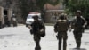 NATO soldiers leave the site of an attack at a hotel on the outskirts of Kabul June 22, 2012. Thirteen people were killed before a long siege was ended at Spozhmai hotel outside the Afghan capital, during which Taliban gunmen took scores of hostages, anot