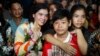 A prominent leader of Cambodia's land rights activist Tep Vanny, second from left, gestures upon the arrival at her home in Boeung Kak, in Phnom Penh, Cambodia, Monday, Aug. 20, 2018. A prominent leader of Cambodia's land rights movement and three women activists who were sent to prison with her were freed Monday under a royal pardon. (AP Photo/Heng Sinith)