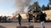 FILE - Smoke bellows after a suicide car bomb blast attacked a military convoy in Lashkar Gah, Helmand province, Afghanistan, Nov. 15, 2015.