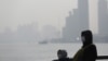 People wear protective masks near the Bund in Shanghai, Jan. 19, 2016. Environmentalists have warned that dirty water is a greater problem than dirty air, and China's top court reaffirmed a record fine on six firms for polluting.