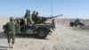 Afghan National Army soldiers guard at a checkpoint on the way to the Sangin district of Helmand province, Afghanistan, Wednesday, Dec. 23, 2015.