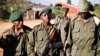 FILE - Child soldier, center, known as "Kadogo," meaning "small one" in Swahili, stands at the front line at Kanyabayonga in eastern Congo.