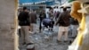 Pakistani security officials examine the site of a suicide attack in Mardan, Pakistan, Dec. 29, 2015.
