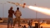 FILE - Fighters of Libyan forces allied with the U.N.-backed government fire a rocket at Islamic State fighters in Sirte, Libya, Aug. 4, 2016. 