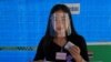 ស្ត្រី​ម្នាក់​ពាក់​របាំង​ការពារ​មុខ​ទៅ​បោះឆ្នោត​នៅ​ក្នុង​ការ​បោះឆ្នោត​ថ្នាក់​ខេត្ត​ នៅ​ខេត្ត Nonthaburi ប្រទេស​ថៃ ថ្ងៃទី២០ ខែធ្នូ ឆ្នាំ២០២០។ 