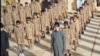 FILE - А YouTube screen grab from an Islamic State propaganda video shows child soldiers at an alleged IS training camp. Wa’il Adil Salman al-Fayad, Islamic State’s so-called minister of information, oversaw the production of IS propaganda videos.