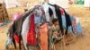 FILE - A displaced child who fled the fighting sits at a makeshift camp in the district of Abs, in Yemen's northwestern Hajjah province, June 10, 2019.