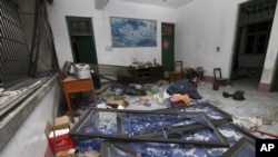 A damaged room in a residential building is seen after several locations were targeted with parcel bombs in the southwestern city of Liuzhou, Guangxi province, Sept. 30, 2015.